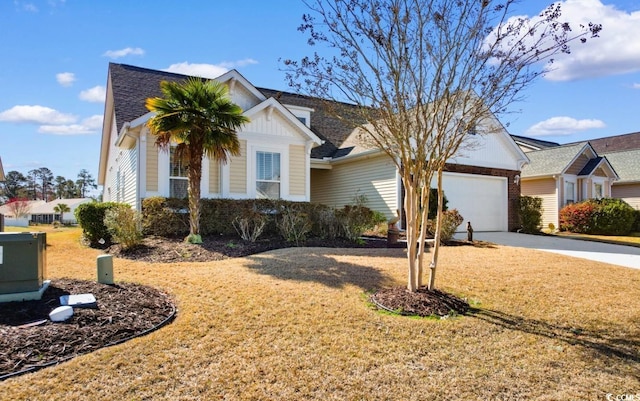 view of front facade with a garage, concrete driveway, a front lawn, and a shingled roof