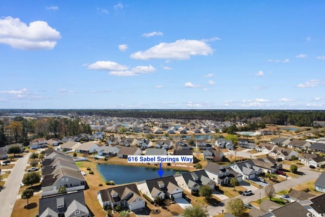 bird's eye view featuring a residential view and a water view