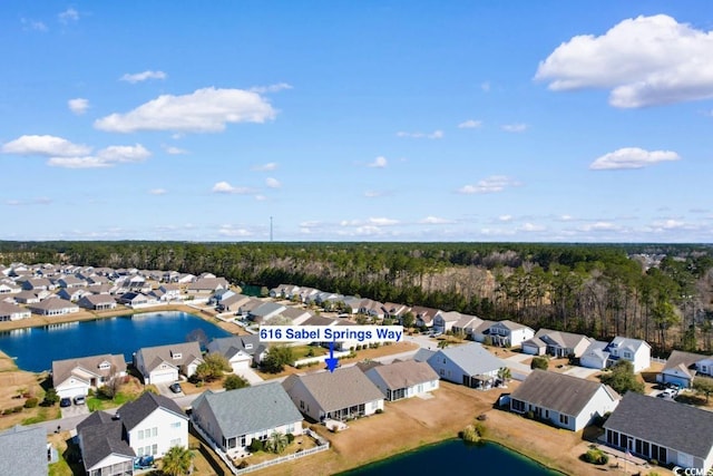 bird's eye view featuring a residential view, a forest view, and a water view