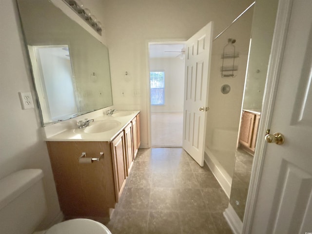 full bath with walk in shower, double vanity, toilet, and a sink