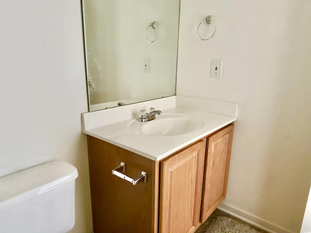 bathroom featuring toilet and vanity