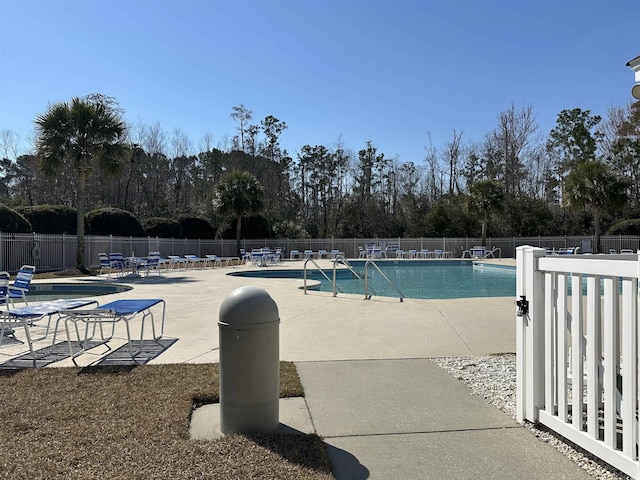 pool featuring a patio and fence