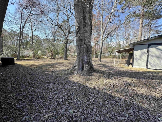 view of yard with a carport and an outdoor structure