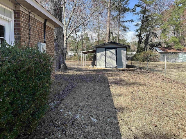 view of yard with a shed, an outdoor structure, and fence