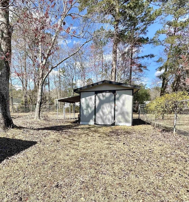 view of shed featuring fence