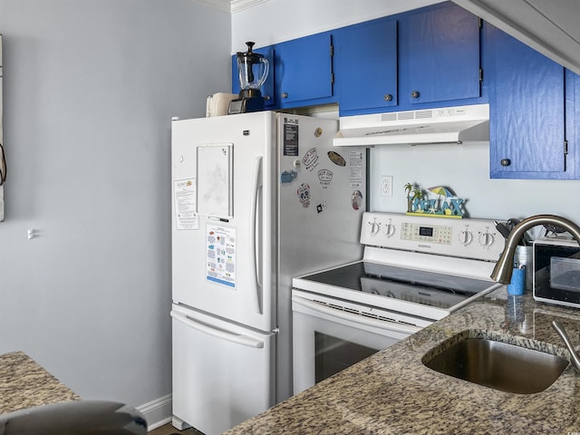 kitchen featuring blue cabinetry, under cabinet range hood, dark stone counters, white appliances, and a sink