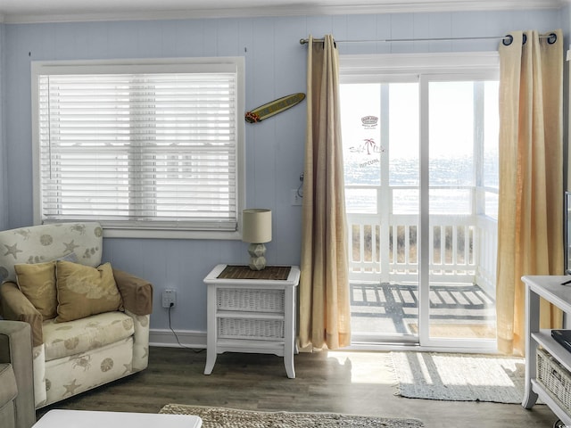 sitting room with wood finished floors and ornamental molding