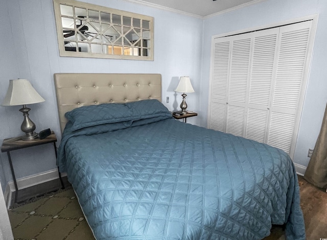 bedroom with a closet, wood finished floors, baseboards, and ornamental molding