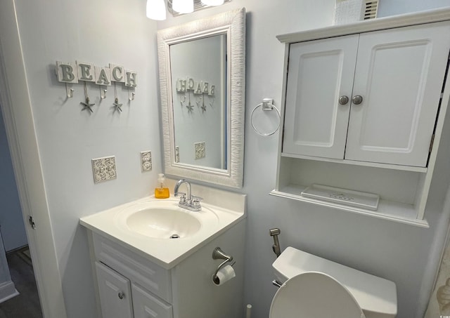 bathroom with toilet and vanity