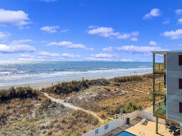 property view of water with fence and a beach view