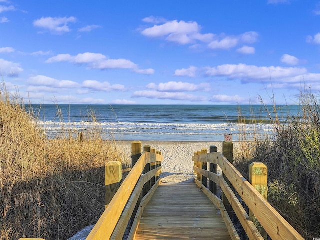 view of property's community with a view of the beach and a water view