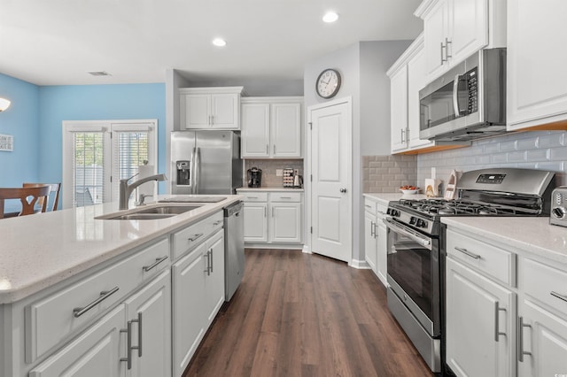 kitchen featuring a sink, appliances with stainless steel finishes, and white cabinetry