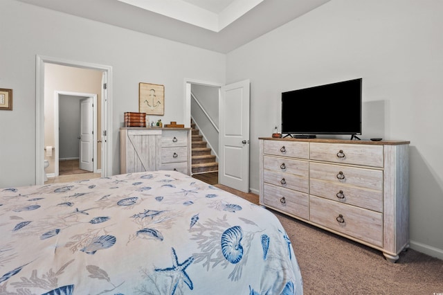 bedroom with baseboards and light carpet