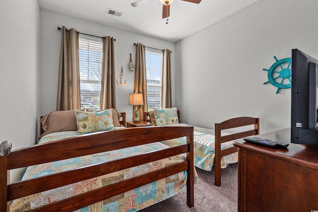 carpeted bedroom featuring visible vents and ceiling fan