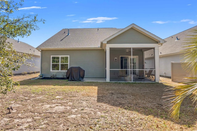 back of property featuring a patio area, roof with shingles, and a sunroom