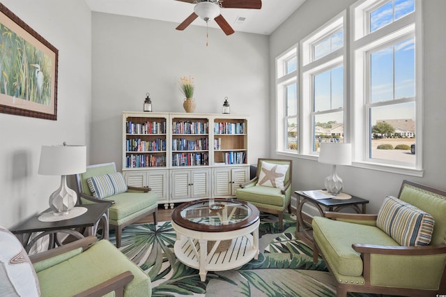 living area featuring visible vents and ceiling fan