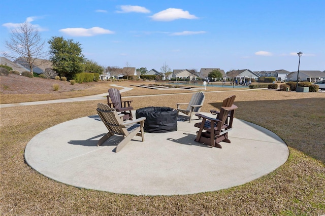 surrounding community featuring a residential view, a lawn, a patio, and an outdoor fire pit