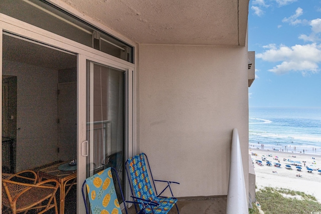 balcony with a view of the beach and a water view