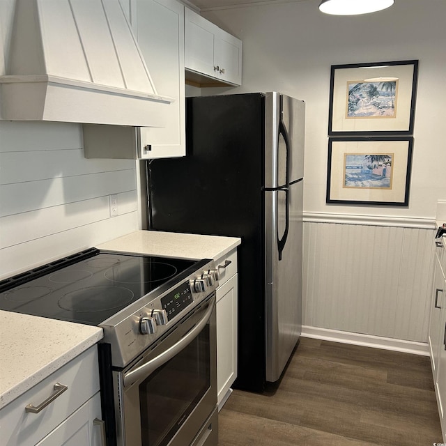 kitchen featuring premium range hood, electric range, a wainscoted wall, dark wood-type flooring, and white cabinets