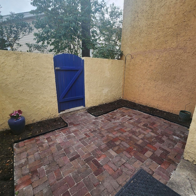 view of patio / terrace featuring a gate and fence