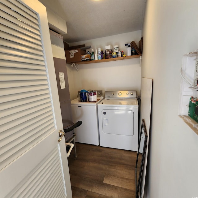 laundry area featuring laundry area, washer and dryer, and dark wood-type flooring