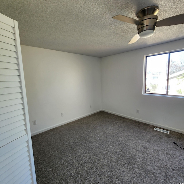 empty room featuring visible vents, a ceiling fan, a textured ceiling, carpet floors, and baseboards