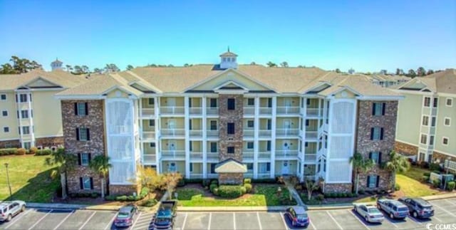 view of building exterior featuring uncovered parking