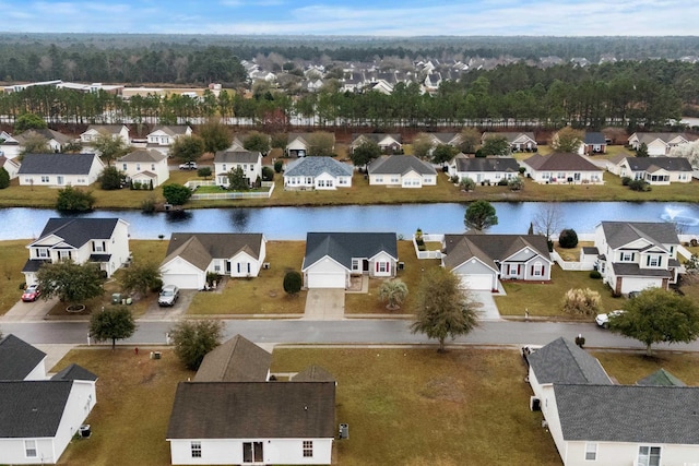 drone / aerial view featuring a residential view and a water view