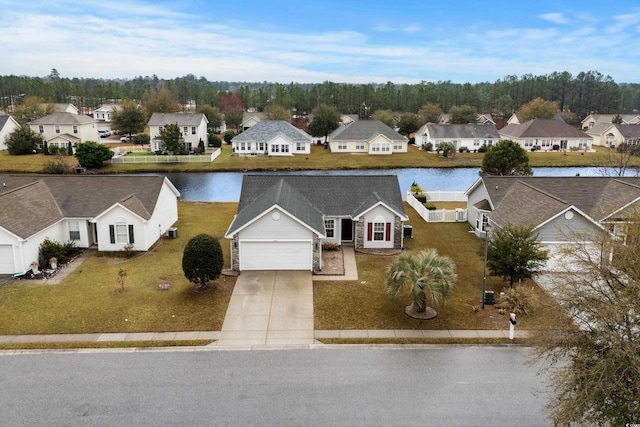 drone / aerial view featuring a residential view and a water view