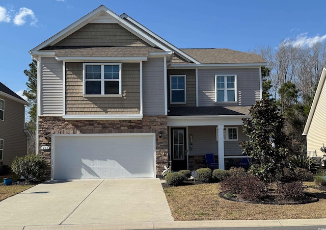 craftsman-style home featuring stone siding, covered porch, concrete driveway, an attached garage, and a shingled roof