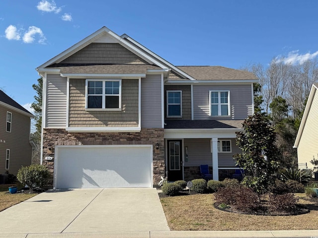 craftsman inspired home with a porch, concrete driveway, a garage, and stone siding