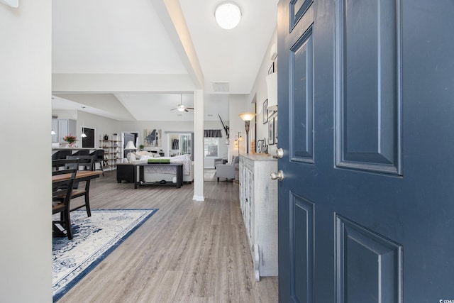 foyer entrance featuring wood finished floors, visible vents, and ceiling fan