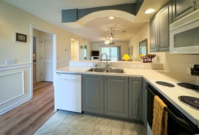 4430 Eastport Blvd Unit L9, Little River, SC 29566 - kitchen featuring a sink, white appliances, light countertops, a peninsula, and gray cabinetry