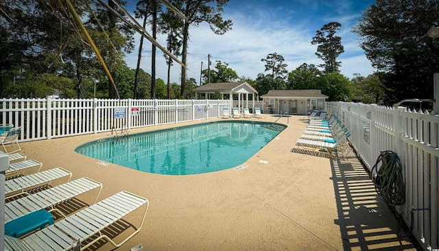 4430 Eastport Blvd Unit L9, Little River, SC 29566 - community pool featuring an outdoor structure, a patio area, and fence