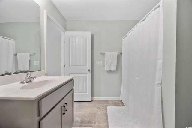 bathroom with vanity and baseboards