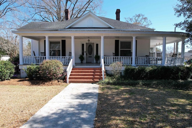 view of front of property with covered porch and a shingled roof