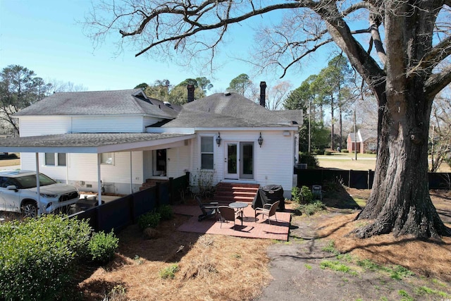 back of house with entry steps, a patio, and french doors