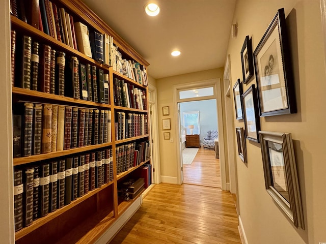 wine room featuring recessed lighting, baseboards, and wood finished floors