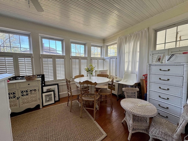 sunroom / solarium featuring a healthy amount of sunlight and wooden ceiling