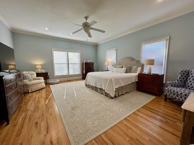 bedroom with light wood finished floors, crown molding, and a ceiling fan