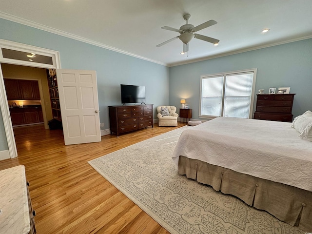 bedroom featuring baseboards, wood finished floors, a ceiling fan, and ornamental molding