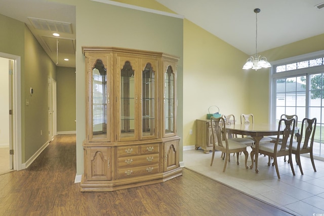 dining area featuring visible vents, baseboards, dark wood-type flooring, and lofted ceiling