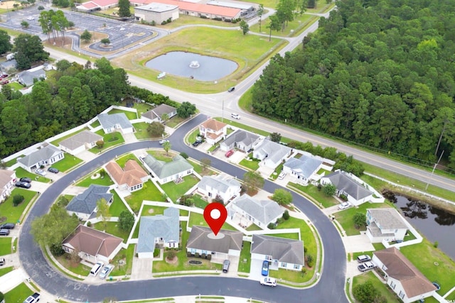 birds eye view of property with a residential view and a water view