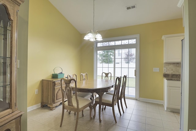 dining area with visible vents, a notable chandelier, light tile patterned floors, baseboards, and vaulted ceiling