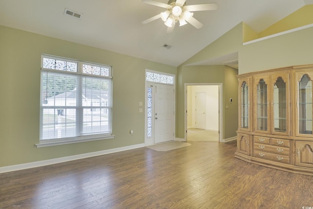 foyer featuring wood finished floors, baseboards, visible vents, lofted ceiling, and ceiling fan