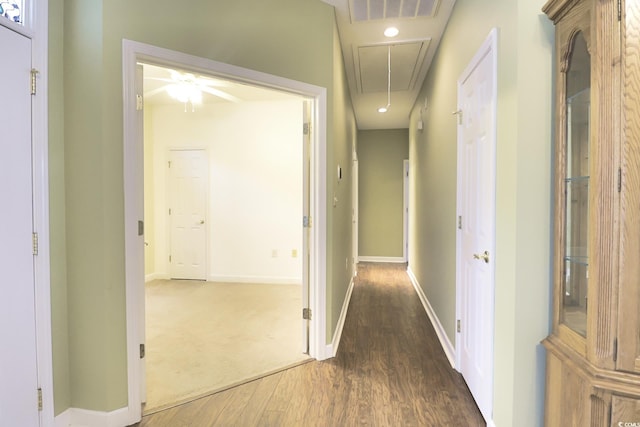 corridor with wood finished floors, visible vents, baseboards, attic access, and recessed lighting