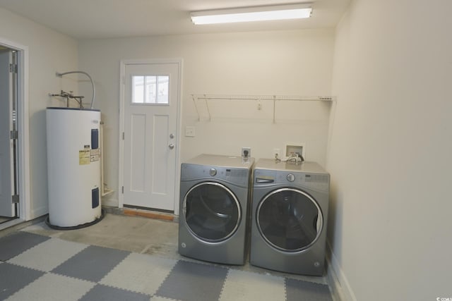washroom with laundry area, washing machine and dryer, and electric water heater