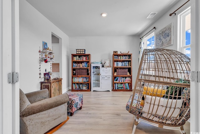 sitting room featuring visible vents and wood finished floors