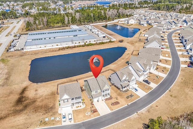 birds eye view of property featuring a water view and a residential view