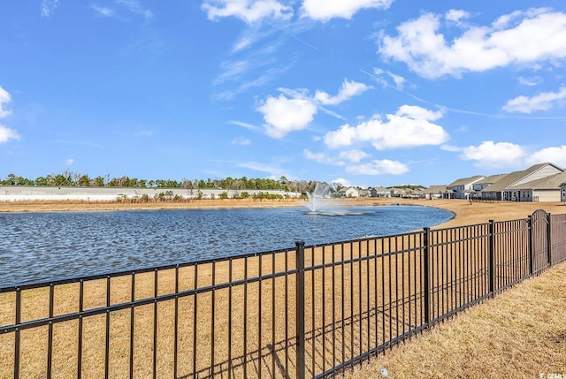 property view of water featuring fence